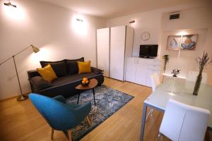 a living room with a couch and a table at La Vie Est Belle in Zagreb