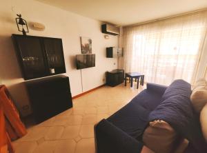 a person laying on a couch in a living room at Novelty I in Salou