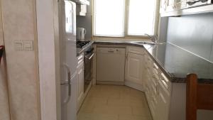 a kitchen with a sink and a stove top oven at Sewdien's Apartment Beverwaard in Rotterdam
