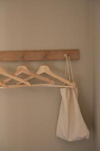 a wooden rack with hangers and a white bag at The Pembroke Arms in Salisbury