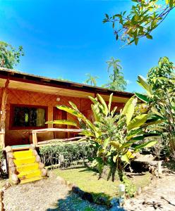 a house with a yellow staircase in front of it at Rio Napo Lodge in Puerto Misahuallí