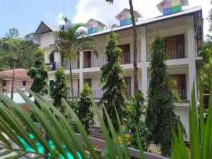 a building with plants in front of it at Palliyadiyil Homestay in Thekkady