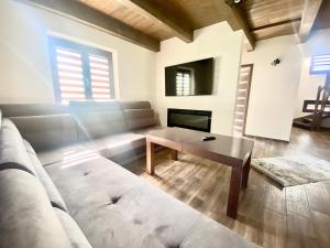 a living room with a couch and a table at Chalet Rosa in Ružiná