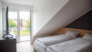Ein Bett oder Betten in einem Zimmer der Unterkunft RheinApart Hotel und Boardinghouse