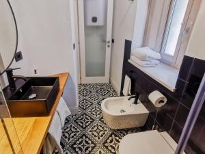 a bathroom with a sink and a toilet at Affittacamere Faber in Tempio Pausania