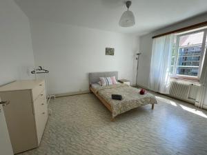 a bedroom with a bed and a dresser in it at Heart of Basel, Beautiful Guest House in Basel