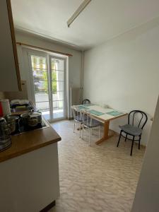 a kitchen and dining room with a table and chairs at Heart of Basel, Beautiful Guest House in Basel
