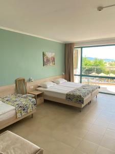 a hotel room with two beds and a window at Sirena Hotel- ALL INCLUSIVE in Sunny Beach +64 photos