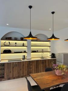 a kitchen with a table and some pendant lights at Dilijan Mountain View, 3 bedroom house in Dilijan