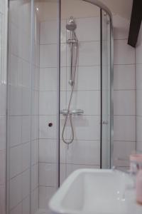 a shower with a glass door in a bathroom at Bv Luxury Apartment Penthouse Conditioning House in Bradford