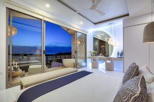 a bedroom with a bed and a view of the ocean at BEACHSIDE VILLA - CLOUD 9 - at BAYSIDE LUXURY VILLAS Samrong Bay Beach, 3 BED 4 BATH, SALT WATER POOL, SEA and SUNSET VIEWS, only 200m walk to the Beach in Amphoe Koh Samui +34 photos
