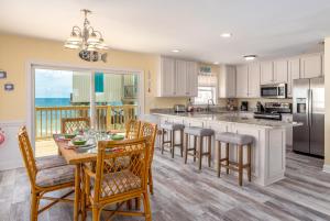 a kitchen with a table and chairs and a dining room at The Boat House - 106 Westward Ho home in Dauphin Island
