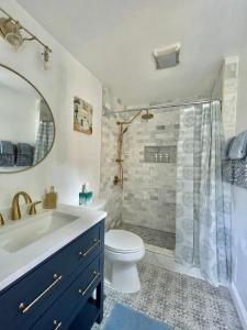 a bathroom with a sink and a toilet and a shower at Brand New, Cozy, Modern, One-bedroom Apartment in Falls Church