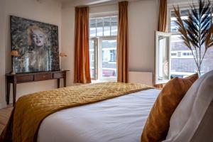 - une chambre avec un lit et une peinture murale dans l'établissement Monroe’s stay, à Deventer