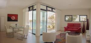 a living room with a table and a red couch at Hotel English Point Marina & Spa in Mombasa