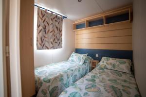a small bedroom with two beds and a window at Remanso do Mar en O Grove in O Grove +14 photos