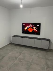a room with a flat screen tv on a white wall at Menachem's Apartment in Bet Sheʼan