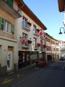 a building with a table in front of it at Hotel de l'Union in Orsières