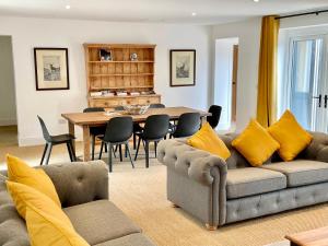 a living room with a couch and a table at Rye Court Cottages in Helmsley +46 photos