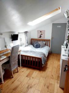 a bedroom with a bed and a desk and a desk at Broadlea of Robgill Country Cottage & Bed and Breakfast in Ecclefechan