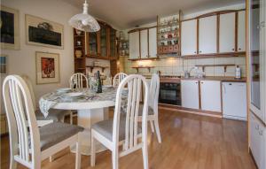 a kitchen with a white table and chairs at Pet Friendly Home In Portoroz With Wifi in Portorož