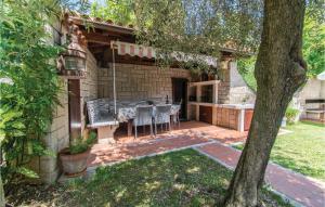 a patio with a table and chairs in a yard at Pet Friendly Home In Portoroz With Wifi in Portorož