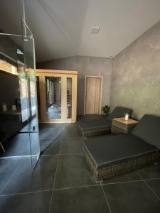 a room with two beds and a glass wall at Wellness pobyt v Pekle in Vrchlabí