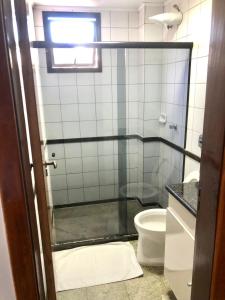 a bathroom with a shower and a toilet at Hotel Rinkao in Cachoeiro de Itapemirim