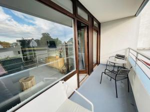 a balcony with a table and a window at Apartment Strandkorv für 2-4 Personen mit Pool in Dahme