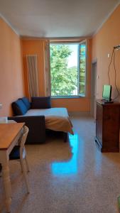 a living room with a bed with blue lights on the floor at La casa del Mago camere e appartamenti in Pissignano