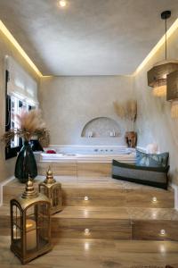 a living room with a couch and a table at Archetypo 1855 - Villas and Suites in Naxos Chora +68 photos