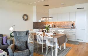 a kitchen and dining room with a table and chairs at Fjellheimen Nr 104 in Sjusjøen