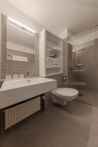 a bathroom with a white sink and a toilet at Michels Gästehaus Meerzeit in Norderney