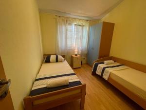 a small room with two beds and a window at Apartment Edita Plano Trogir with private pool in Plano +16 photos