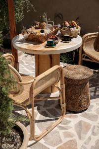 a table with baskets of food on top of it at Archetypo Villas and Suites in Naxos Chora