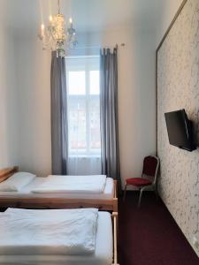Postel nebo postele na pokoji v ubytování Hotel Dejmalik