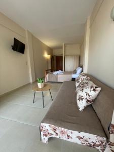a hotel room with a bed and a table at Villa Helios in Stavros