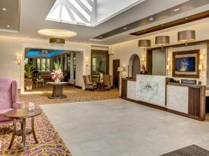 a lobby of a hotel with a reception desk at Everglades Hotel in Derry Londonderry