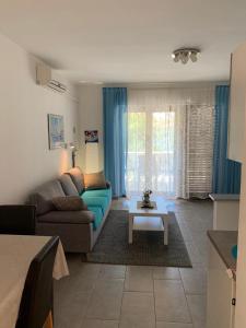 a living room with a couch and a table at Apartments Toni-Malinska in Malinska
