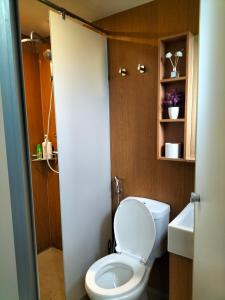 a small bathroom with a toilet and a sink at Hani Homestay WiFi Netflix Secure parking KLIA USIM INTI Aeon mall in Nilai