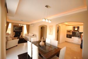 a dining room and living room with a dining table at Sadev Turizm Belek Family Villas in Belek