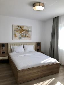 Ένα ή περισσότερα κρεβάτια σε δωμάτιο στο Modern and New Apartments in North of Timisoara - PNM Residence +140 φωτογραφίες