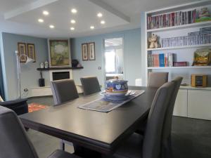 a dining room with a wooden table and chairs at Suite Minerva in Polignano a Mare
