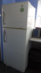a white refrigerator sitting in a kitchen next to a window at 94 Main Street - Pembroke Holiday Home in Pembroke