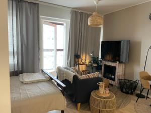 TV at/o entertainment center sa Stunning 1-Bed Apartment in Tampere