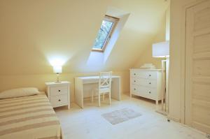 a bedroom with a bed and a desk and a window at Space in Szklarska Poręba