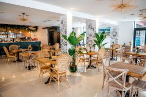 a restaurant with wooden tables and chairs and a bar at Auberge Koskenia in Bidart