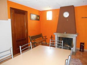 a dining room with a table and a fireplace at Casa do Souto in Quinta do Souto