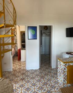 a hallway with a staircase and a room with a tile floor at Dammuso Pensare alla Luna in Pantelleria