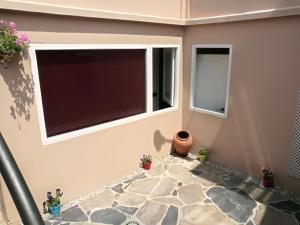 a living room with a window and a stone floor at Albergue Savior in Lourenzá